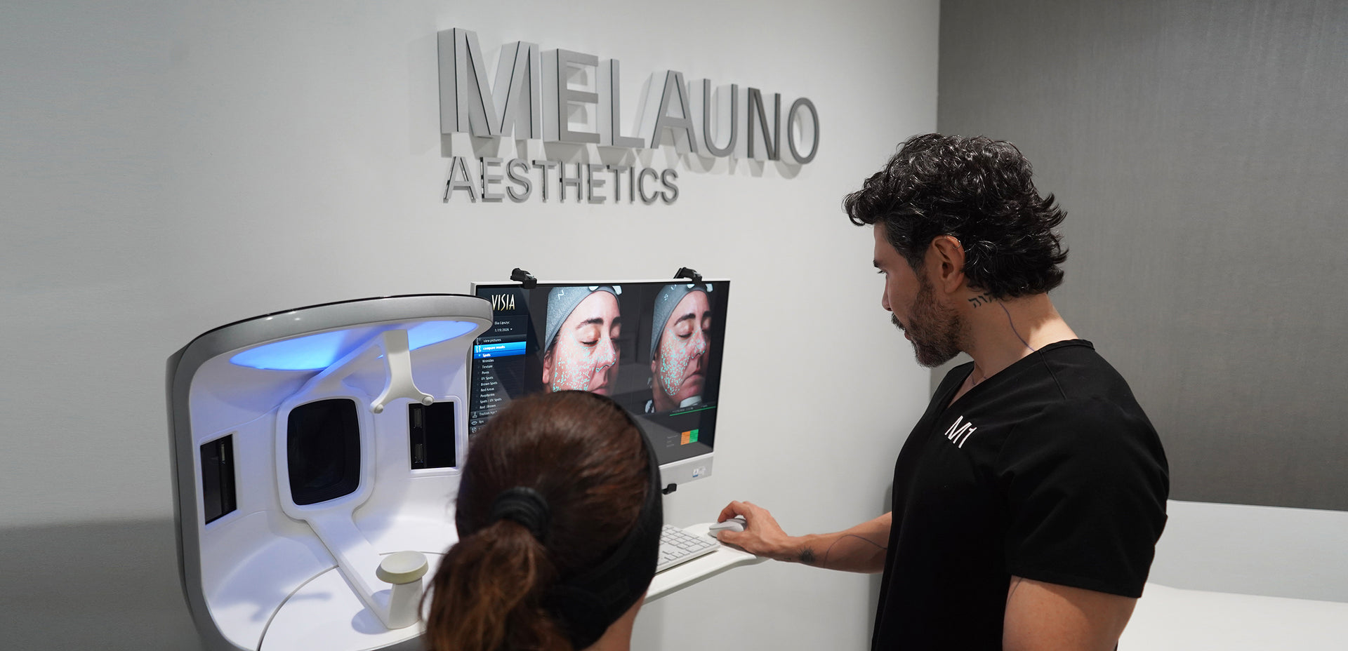 Person using a skincare device with Melauno Aesthetics branding in the background